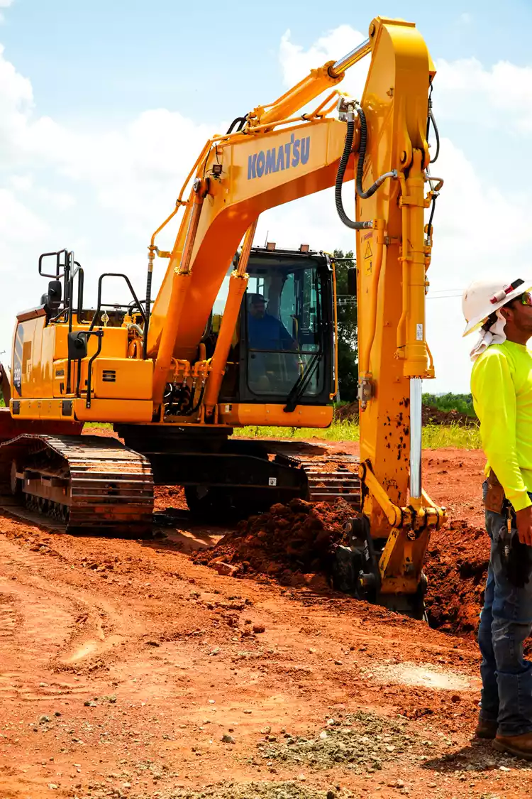 Komatsu PC220LCi-12 excavator at work, with new cab design and Intelligent Machine Control 3.0 technology available at Kirby-Smith Machinery.
