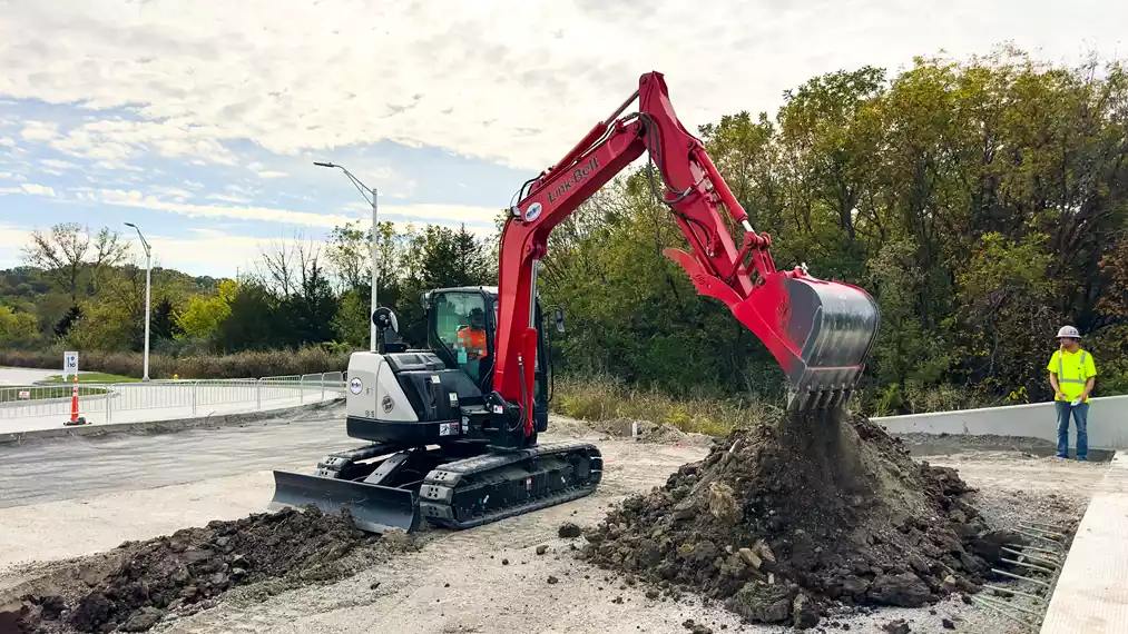 An EPIC Concrete Construction operator digs a utility trench with a Link-Belt 80 X3 Spin Ace excavator.