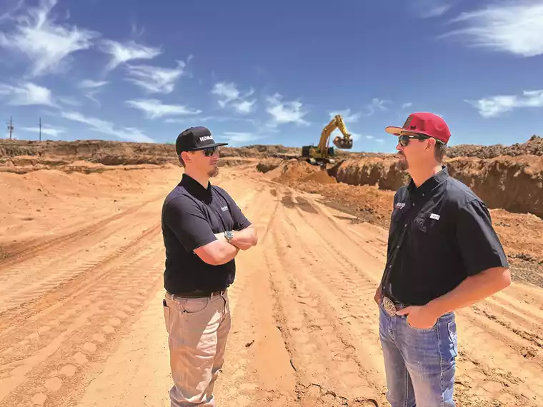 KSM Territory Sales Manager Zac Jarrett (left) talks with Silver Spur Energy Services owner and West Point Silica co-owner Sterling Miller at West Point Silica’s damp sand facility. 