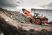 New Hitachi Loader lifting dirt and rocks